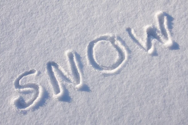 Intoetsen van tekst op de sneeuw — Stockfoto
