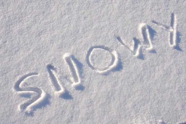 Intoetsen van tekst op de sneeuw — Stockfoto