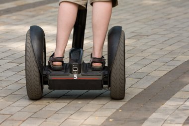 Man goes on an electric scooter. clipart