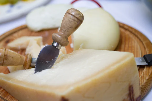 stock image Cheese on wooden platter.