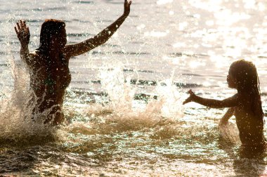 Family splashes in water clipart