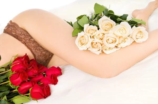 Pernas e rosas Fotografias De Stock Royalty-Free