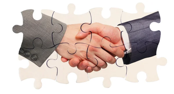 Shaking hands inside puzzle pieces — Stock Photo, Image