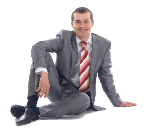 Πορτρέτο του επιχείρηση άνθρωπος κάθεται στο πάτωμα απομονωθεί σε λευκό φόντο — Φωτογραφία Αρχείου