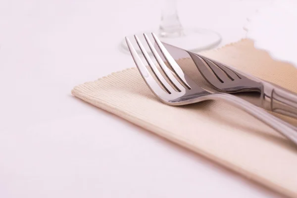 Table knife and fork over plate — Stock Photo, Image