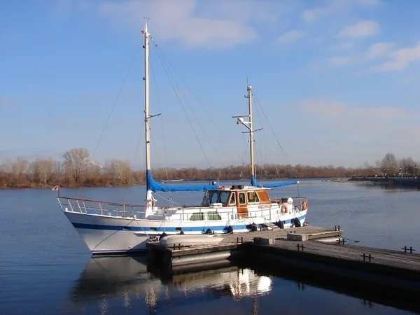 stock image Boat moored to a wooden pier