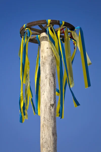Wheel with colored ribbons on a background of blue sky — Stock Photo, Image