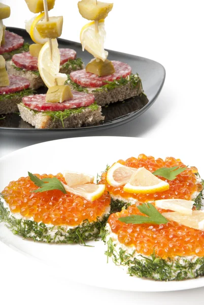 Smörgåsar med röd kaviar på vit bakgrund — Stockfoto