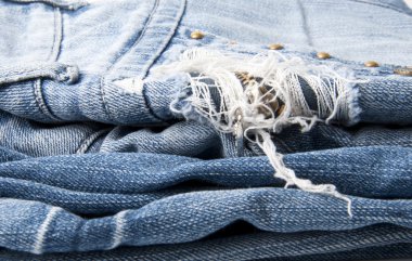 Torn old blue jeans background clipart