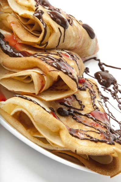 Pancakes with chocolate and strawberry syrup