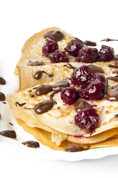 Pancakes with cherry jam and chocolate icing — Stock Photo, Image