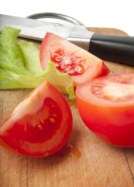 Tomatoes on a chopping board — Stock Photo, Image