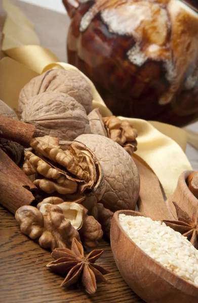 Wood nut, walnut, anise, cinnamon and sesame against a dark background — Stock Photo, Image