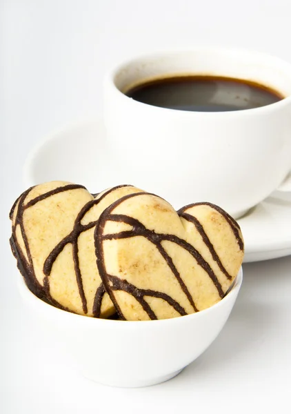 Šálek kávy a cukroví s čokoládou — Stock fotografie