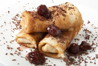 Pancakes with chocolate and strawberry syrup