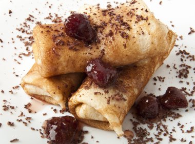 Pancakes with chocolate and strawberry syrup