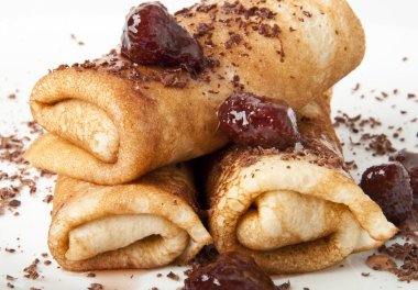 Pancakes with chocolate and strawberry syrup