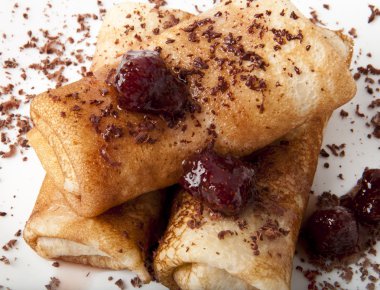 Pancakes with chocolate and strawberry syrup