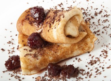 Pancakes with chocolate and strawberry syrup