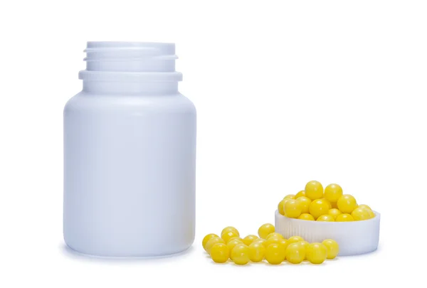 stock image Yellow pills and a plastic bottle