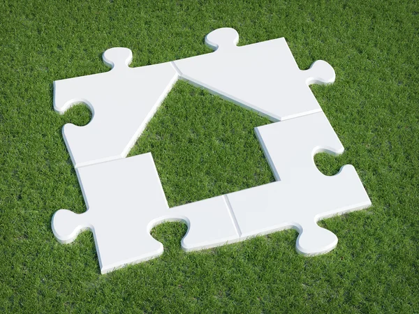 Puzzle Haus Symbol auf Gras — Stockfoto