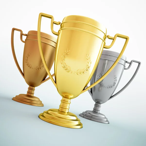 Gold, silver and bronze - three shiny trophies. Stock Photo