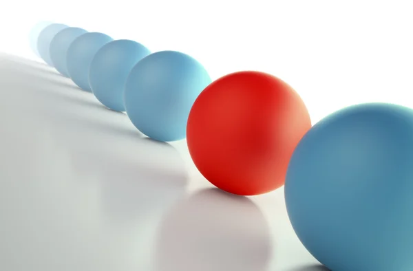 Brut de sphères bleues avec une sphère rouge unique au milieu — Photo