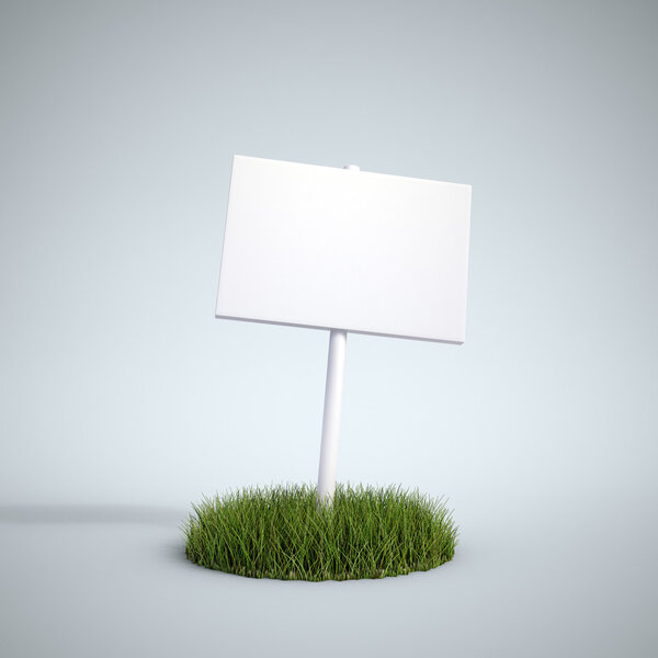 An empty sign on a patch of grass