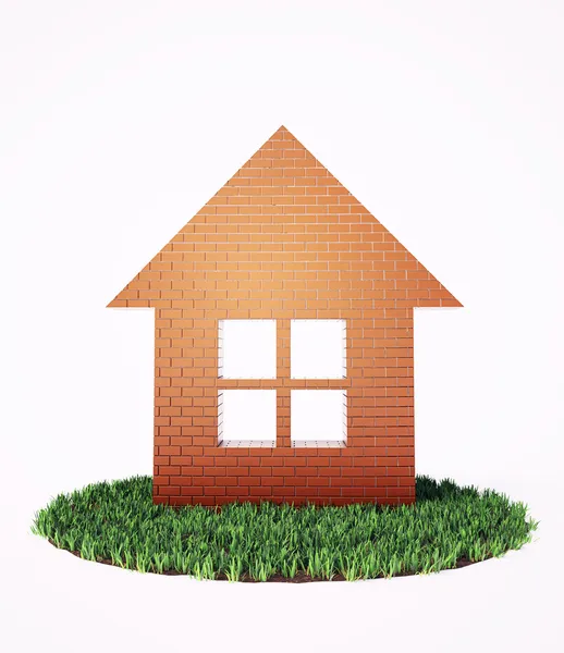 Um símbolo de casa de tijolo em um pedaço de grama — Fotografia de Stock