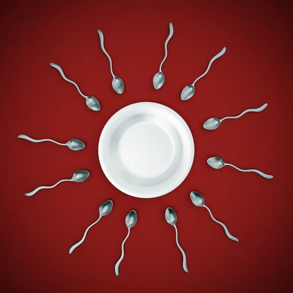 stock image Sperm cell shaped spoons straggleing to get to an empty plate