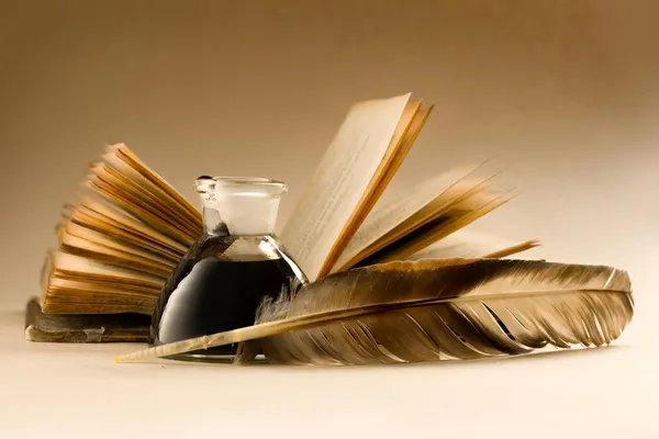 An old book with a feather — Stock Photo, Image