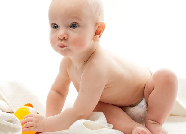 Baby in towels with a duck — Stock Photo, Image