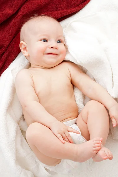 Baby in white and red towels — Stock Photo, Image