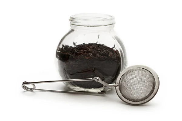 Glass container with tea — Stock Photo, Image