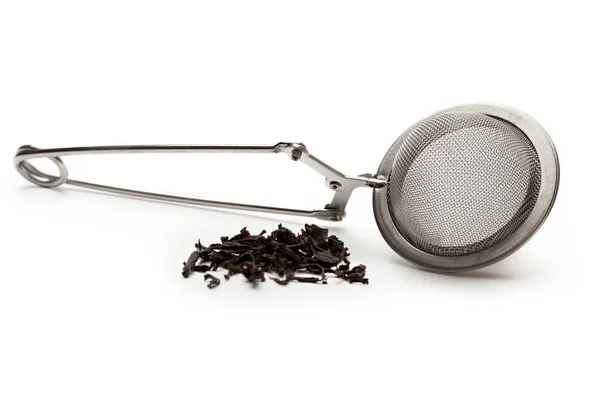 Tea strainer with a pinch of tea — Stock Photo, Image