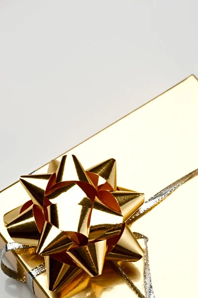 Gift box with a golden bow — Stock Photo, Image