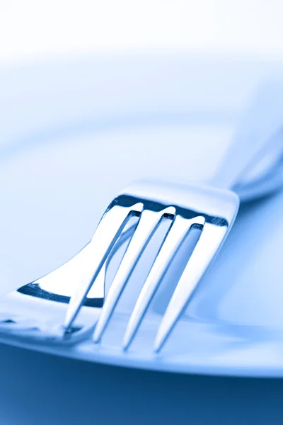 Two forks on a plate Stock Photo