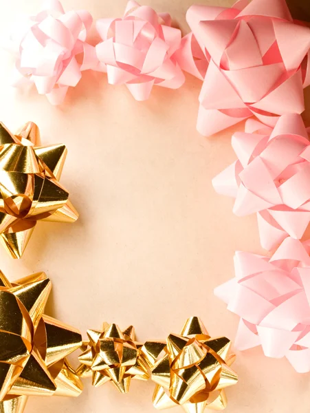 A frame of pink and golden bows — Stock Photo, Image