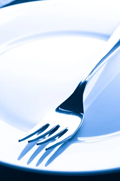 A fork on a plate — Stock Photo, Image