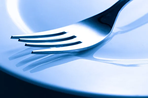 A fork on a plate — Stock Photo, Image