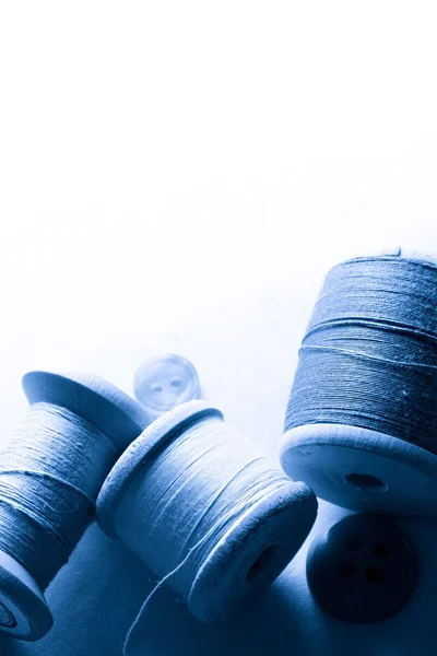 Wooden bobbins in blue light — Stock Photo, Image
