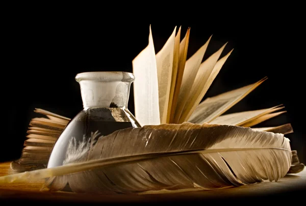 A feather, inkpot, old book and keylock — Stock Photo, Image