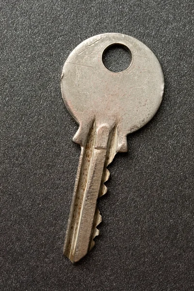 Key on the grey background — Stock Photo, Image