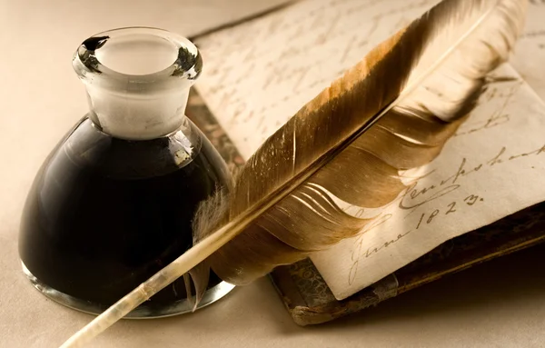 An old book with a feather — Stock Photo, Image