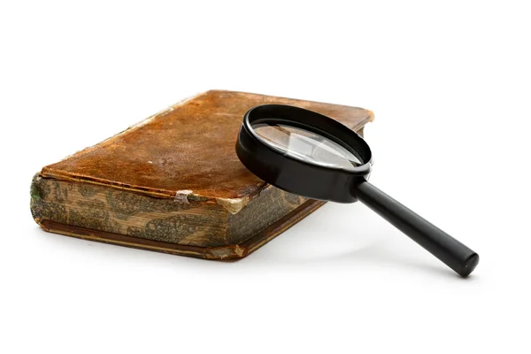 Magnifying glass and old book — Stock Photo, Image