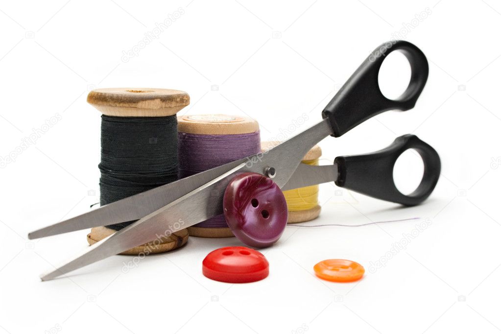Thread bobbin, scissors and buttons