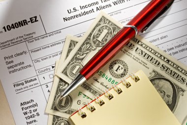 Tax form, pen, notepad and dollars clipart