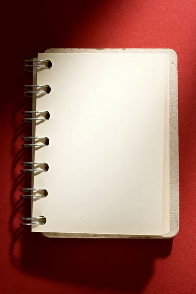 Notepad on red background — Stock Photo, Image