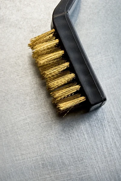 Metal brush on steel background — Stock Photo, Image