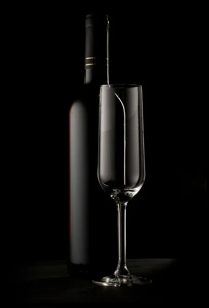 Bottle of wine and empty glass — Stock Photo, Image